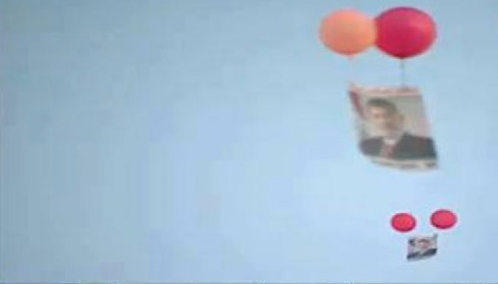 صور الرئيس مرسي تناطح السحاب في ميدان النهضة